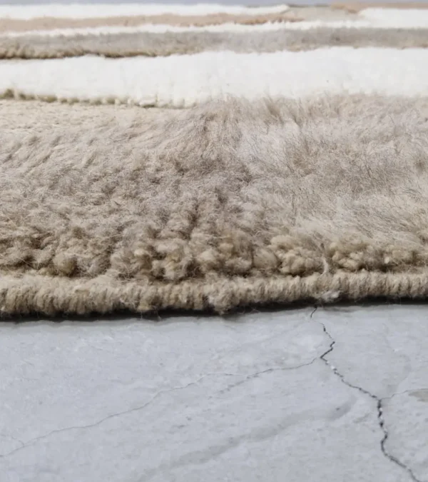 zoomed in view of Handmade Moroccan high/low pile rug with abstract neutral pattern