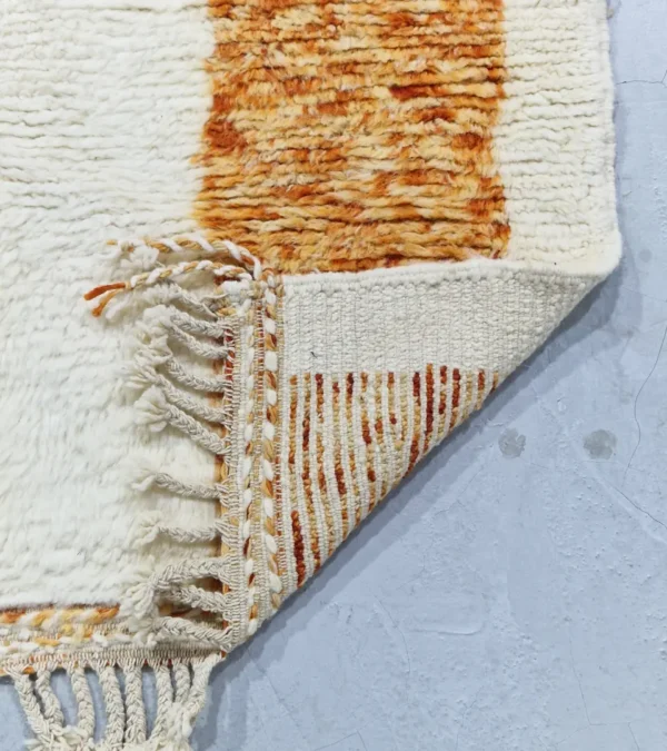 detailed view of Golden Horizon Moroccan rug with golden yellow and off-white abstract shapes