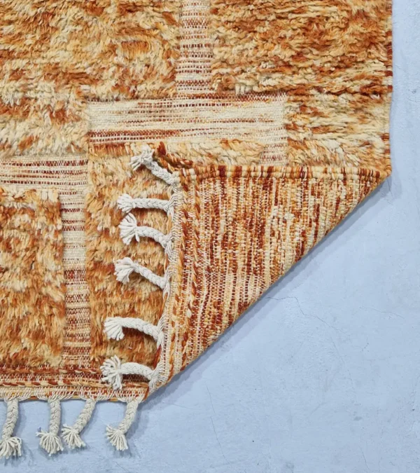 detailed view of Goldenrod wool rug with plush high-pile texture and beige geometric grid pattern
