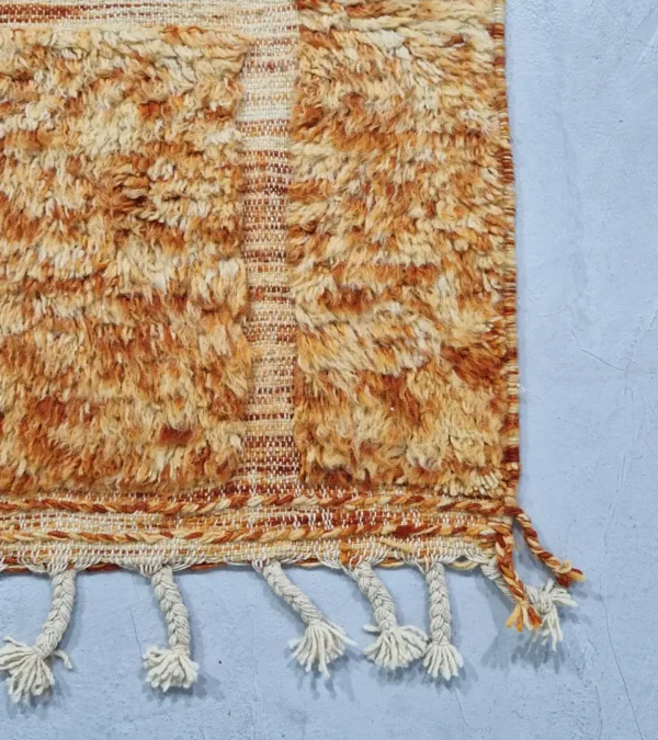 detailed view of Goldenrod wool rug with plush high-pile texture and beige geometric grid pattern