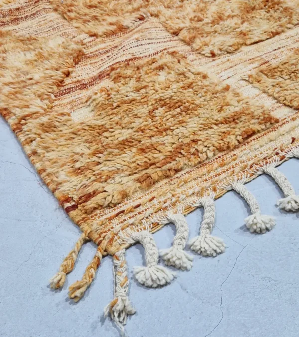 detailed view of Goldenrod wool rug with plush high-pile texture and beige geometric grid pattern