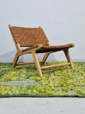 Hand-knotted Moroccan rug with sculpted high-pile texture, variegated green tones, and dual-pattern design with tassels in room