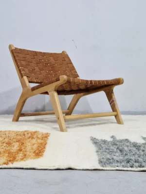 Hand-knotted Moroccan wool rug with abstract color-block design in yellow, charcoal, and terracotta on a cream background in room