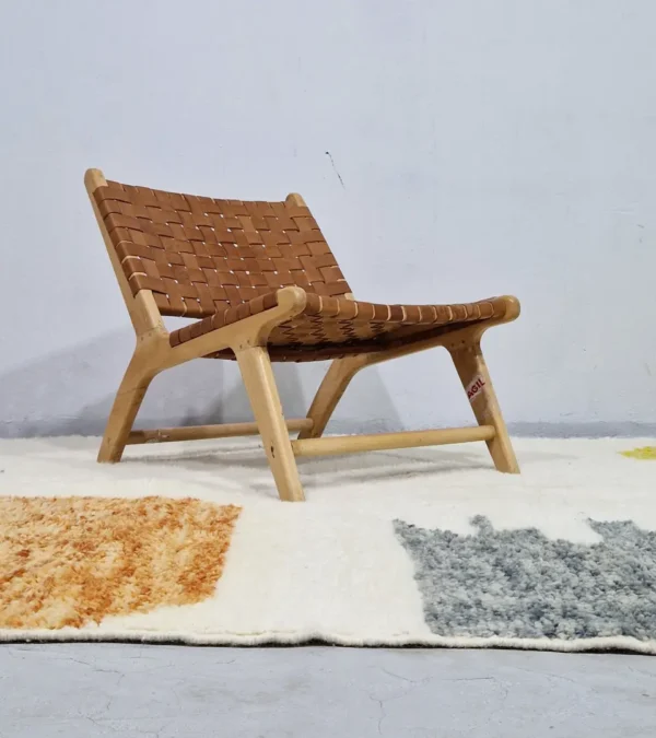 Hand-knotted Moroccan wool rug with abstract color-block design in yellow, charcoal, and terracotta on a cream background in room