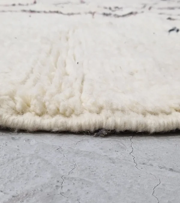 zoomed in view of Handmade minimalist Moroccan wool rug with colorful abstract lines on a high pile