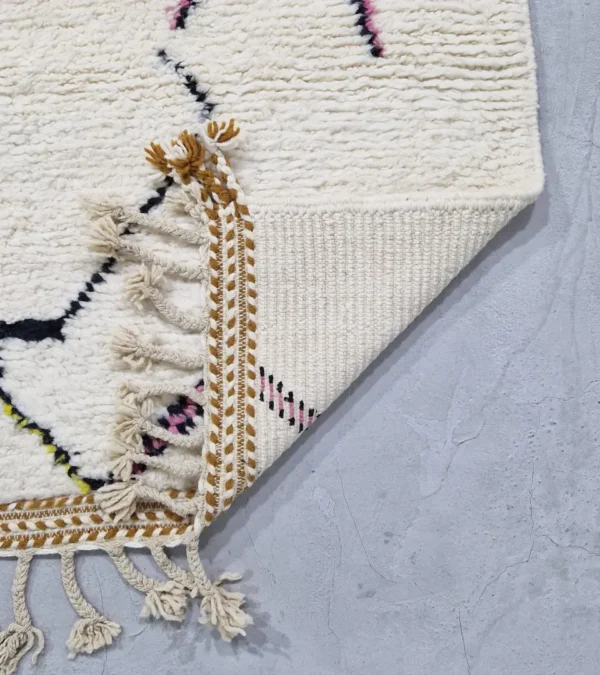 detailed view of Handmade minimalist Moroccan wool rug with colorful abstract lines on a high pile