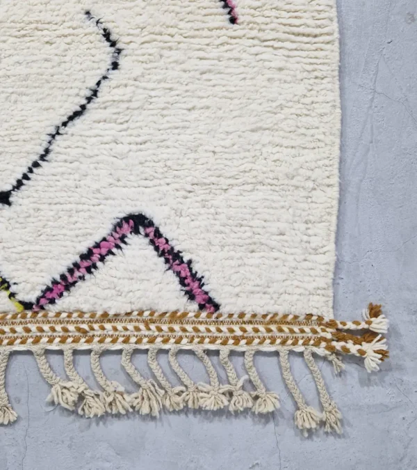 detailed view of Handmade minimalist Moroccan wool rug with colorful abstract lines on a high pile