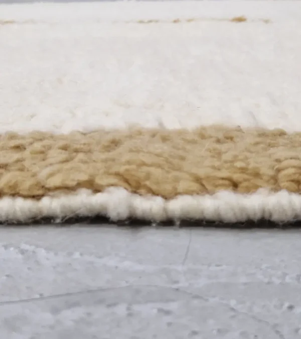 zoomed in view of Mauve Accent Abstract Moroccan Rug with camel, off-white, and mauve color blocks