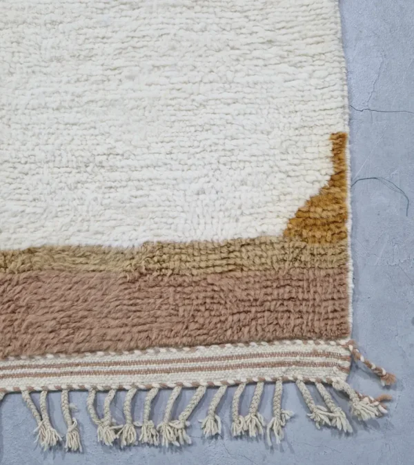 detailed view of Mauve Accent Abstract Moroccan Rug with camel, off-white, and mauve color blocks