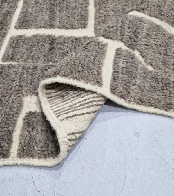 detailed view of Neutral modern geometric wool rug with muted brown and cream high-low pile design