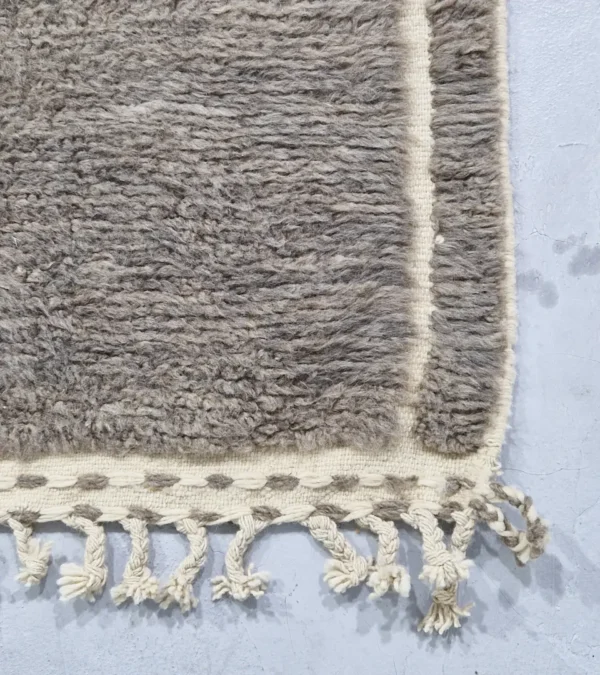 detailed view of Neutral modern geometric wool rug with muted brown and cream high-low pile design