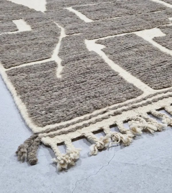 detailed view of Neutral modern geometric wool rug with muted brown and cream high-low pile design