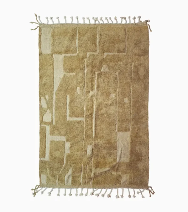 top view of Handmade Moroccan wool rug in sandy beige with sculpted off-white linework and tassels