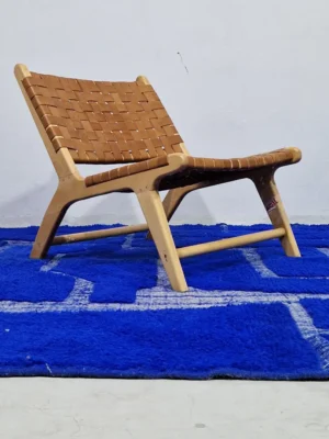 Handmade Moroccan rug with bold blue base and sculpted geometric grid in room