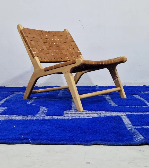 Handmade Moroccan rug with bold blue base and sculpted geometric grid in room