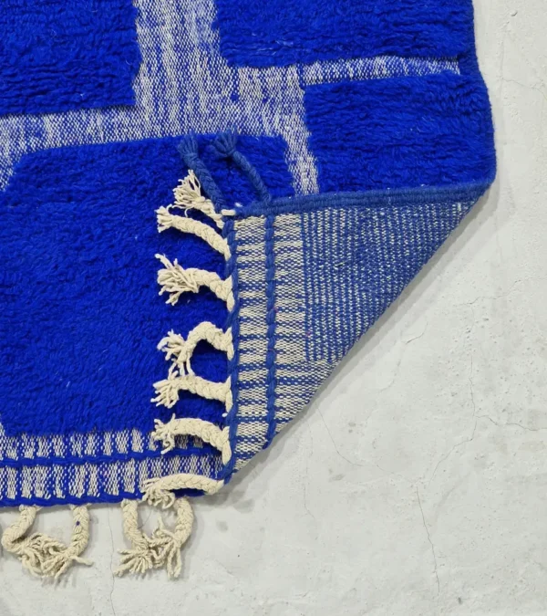detailed view of Handmade Moroccan rug with bold blue base and sculpted geometric grid