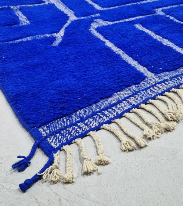 detailed view of Handmade Moroccan rug with bold blue base and sculpted geometric grid