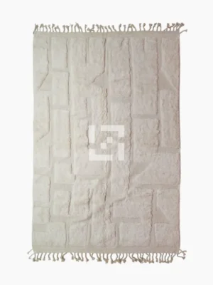 top view of Handwoven cream wool rug with sculpted high-low pile geometric pattern