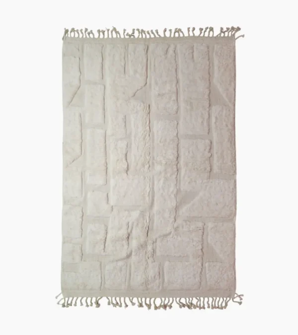 top view of Handwoven cream wool rug with sculpted high-low pile geometric pattern