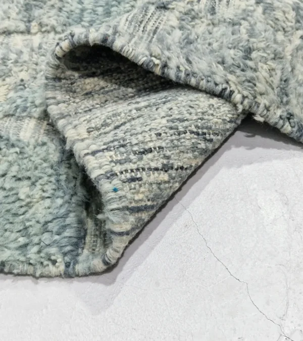 detailed view of Modern Moroccan rug in muted blue-gray tones with geometric design