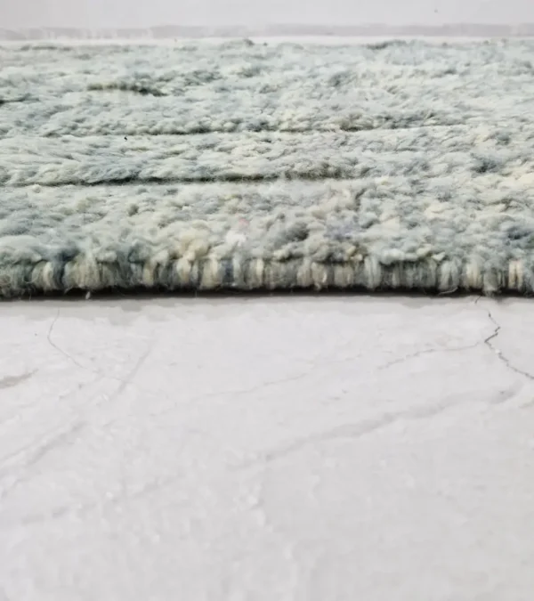 zoomed in view of Modern Moroccan rug in muted blue-gray tones with geometric design