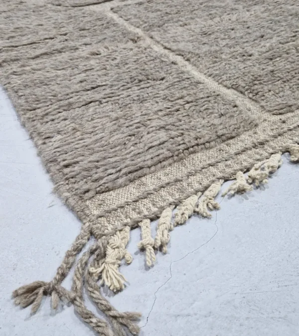 detailed view of Stone gray Moroccan rug with sculpted geometric grid pattern