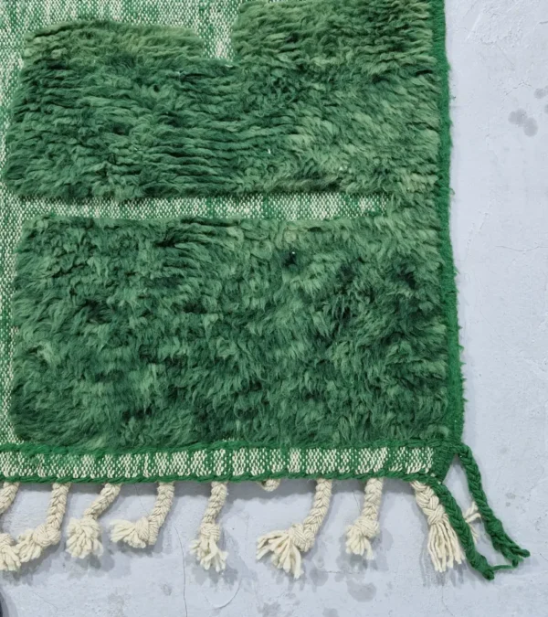 detailed view of Hand-knotted Moroccan wool rug with high-low geometric grid in green and off-white tones