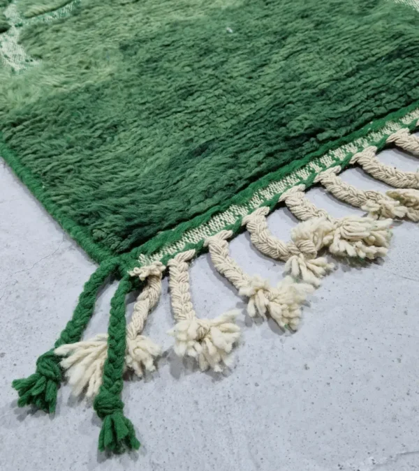 detailed view of Hand-knotted Moroccan wool rug with high-low geometric grid in green and off-white tones