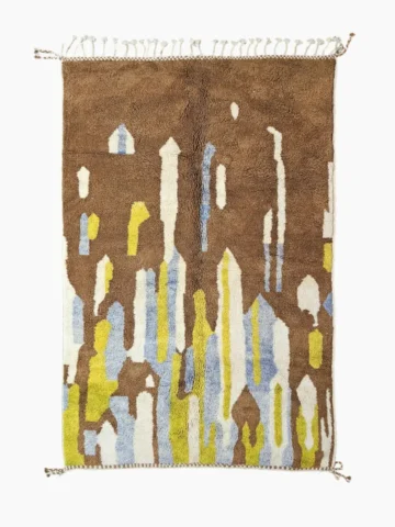 Top View of Zola Beni Ourain Hand-knotted wool rug with an abstract design of vertical white, blue, and green shapes on a brown background