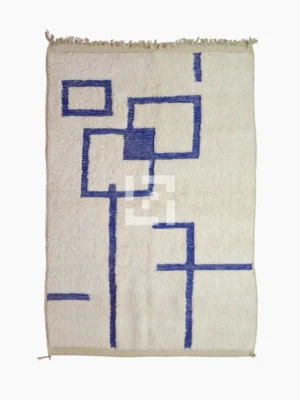 Top View of Zola handmade Beni Ourain wool rug with a minimalist geometric design of royal blue lines and shapes on an ivory background