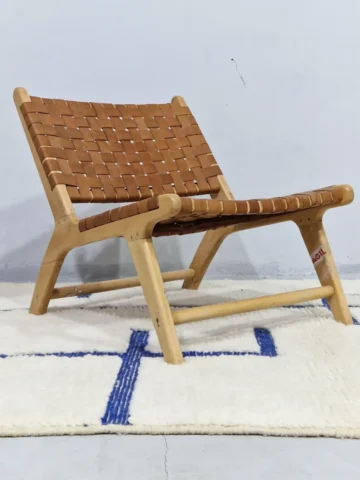 Zola handmade Beni Ourain wool rug with a minimalist geometric design of royal blue lines and shapes on an ivory background in room