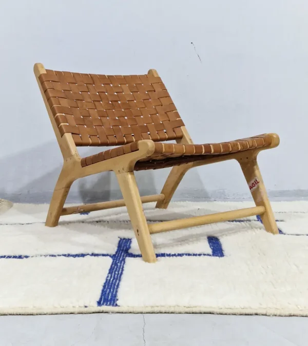 Zola handmade Beni Ourain wool rug with a minimalist geometric design of royal blue lines and shapes on an ivory background in room
