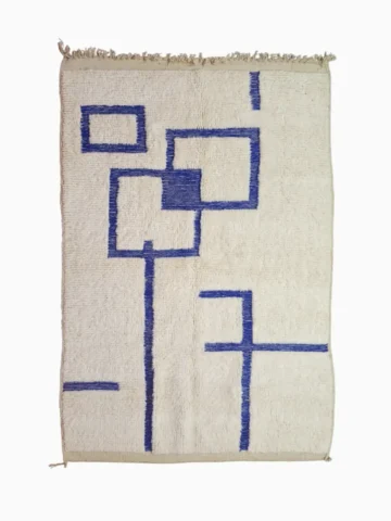 Top View of Zola handmade Beni Ourain wool rug with a minimalist geometric design of royal blue lines and shapes on an ivory background