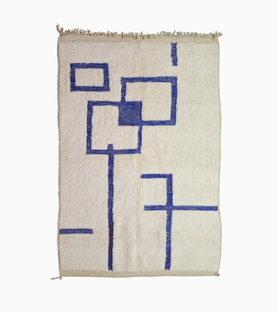 Top View of Zola handmade Beni Ourain wool rug with a minimalist geometric design of royal blue lines and shapes on an ivory background