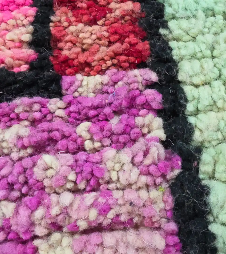 Artisan hand knotted wool rug in pink tones