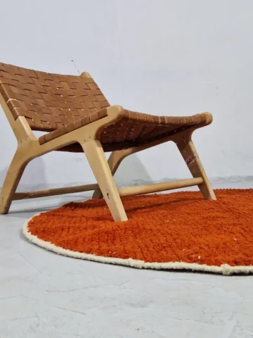 Minimalist round area rug in warm earthy orange tones